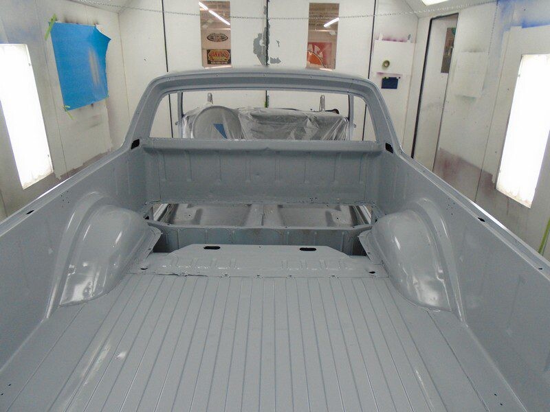 Gray truck bed in paint booth.
