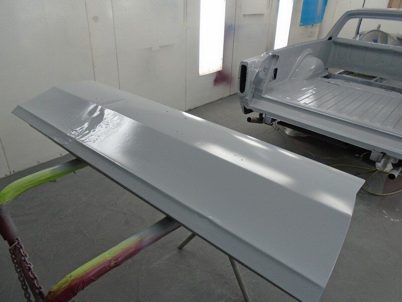 Primered car body panel and truck bed.