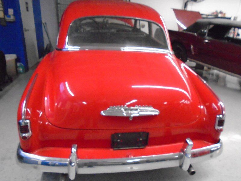 Red classic car, rear view.