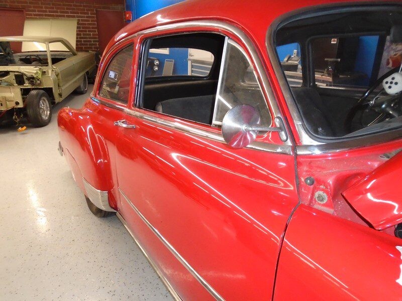 Red classic car, side view.