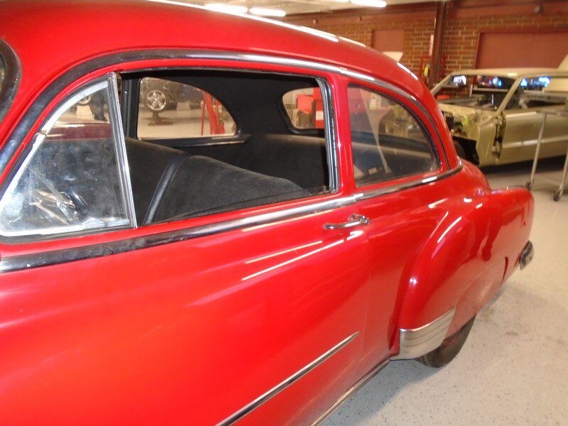 Red classic car, side view.