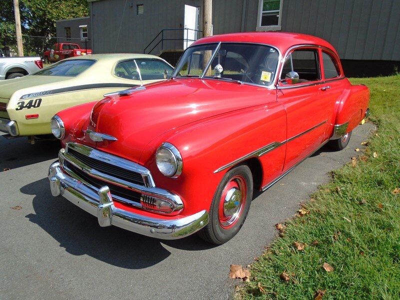 Red classic Chevrolet car parked outdoors.