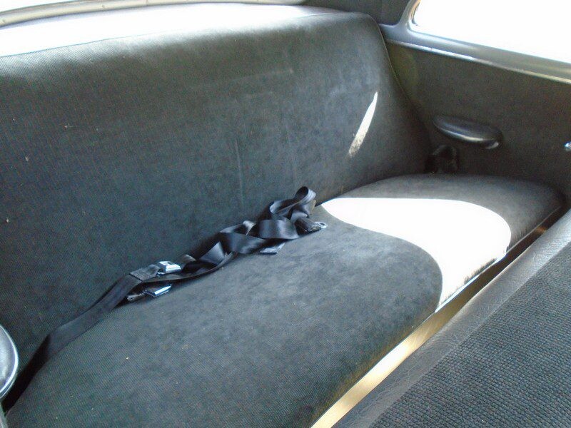 Classic car's rear seat with seatbelts.