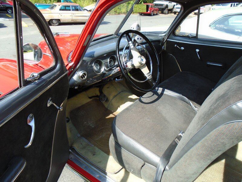 Vintage red coupe interior with fuzzy dice
