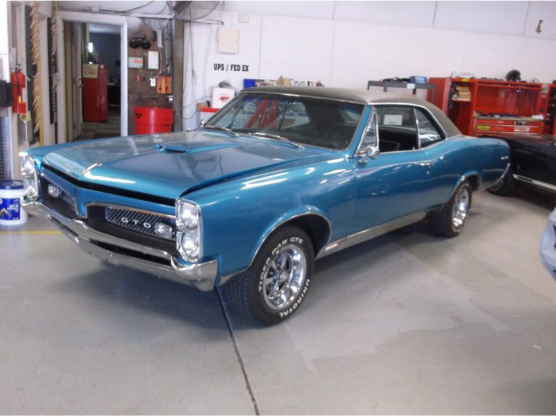 Here's an alt tag for the image: Blue Pontiac GTO classic car.