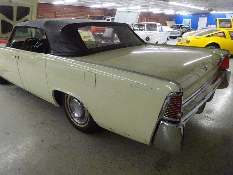 Beige convertible Lincoln Continental classic car.