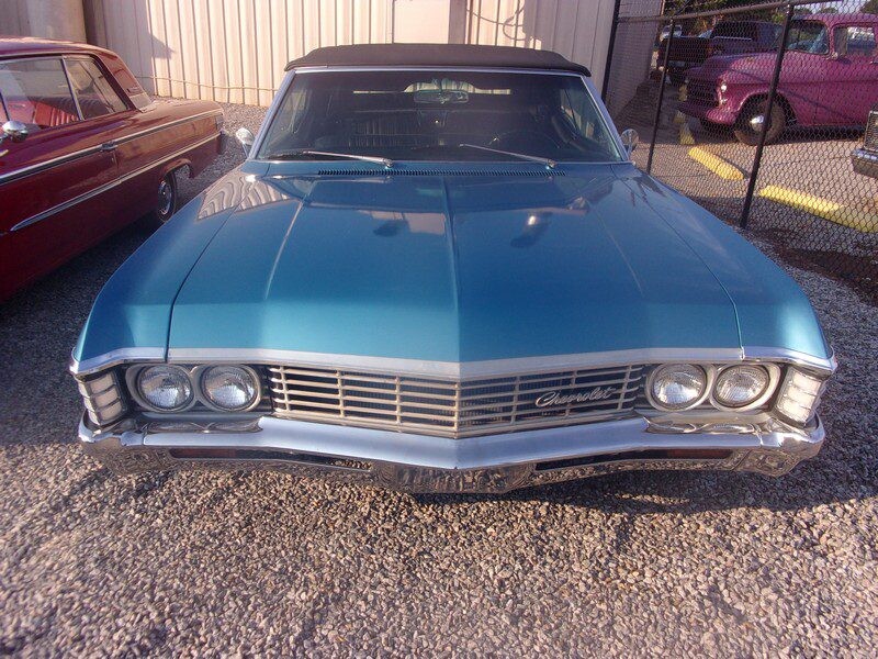 Blue Chevrolet Impala convertible.