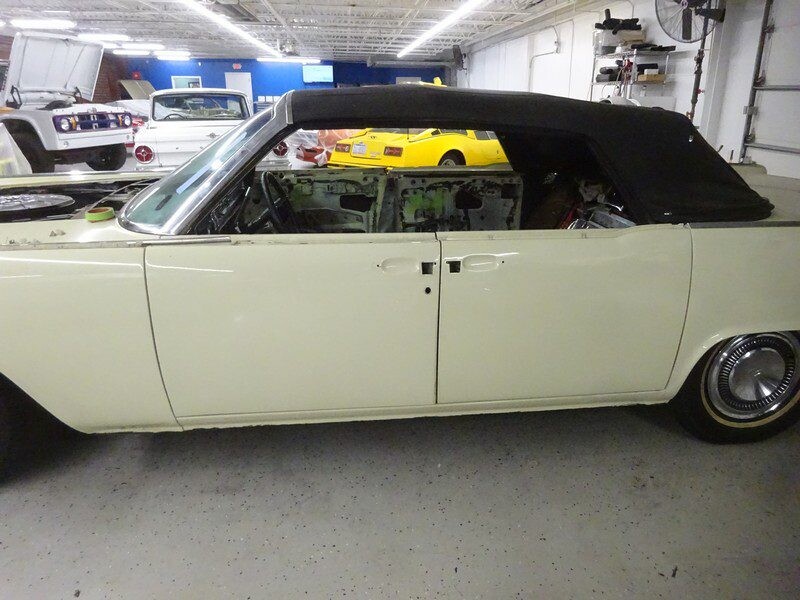 Cream-colored classic convertible car restoration.