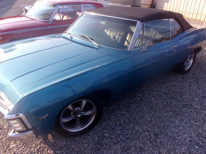 Blue classic car convertible parked outdoors.