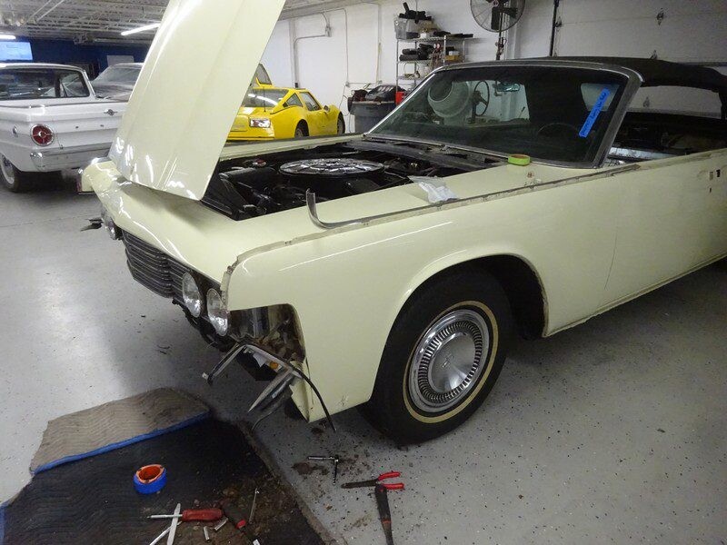Image of classic white car with hood open