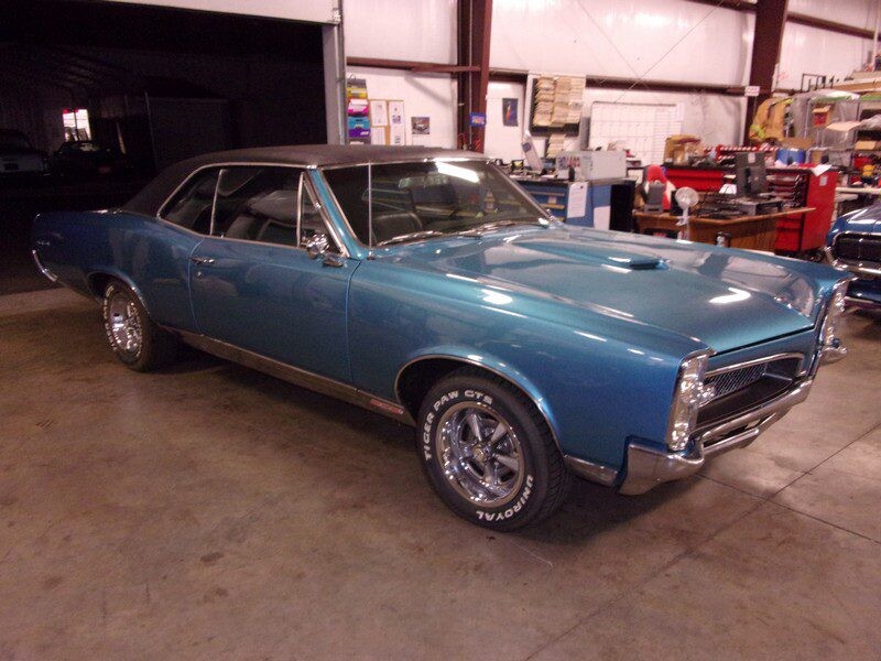 Blue 1969 Pontiac GTO in garage.