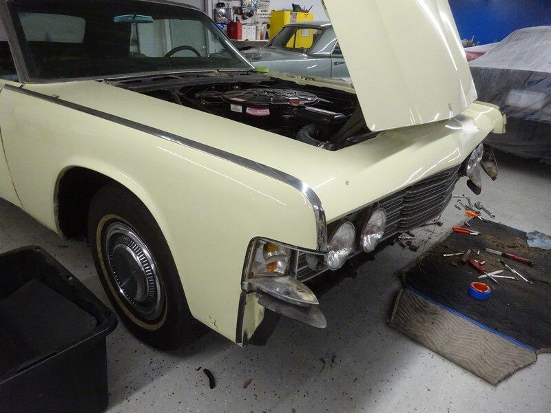 Damaged vintage Lincoln Continental under repair.
