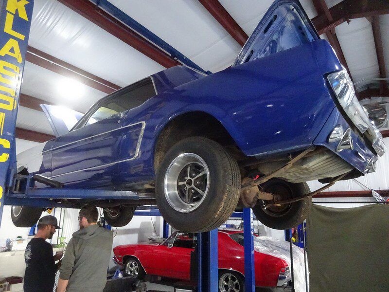 Blue Ford Mustang undergoing repair.