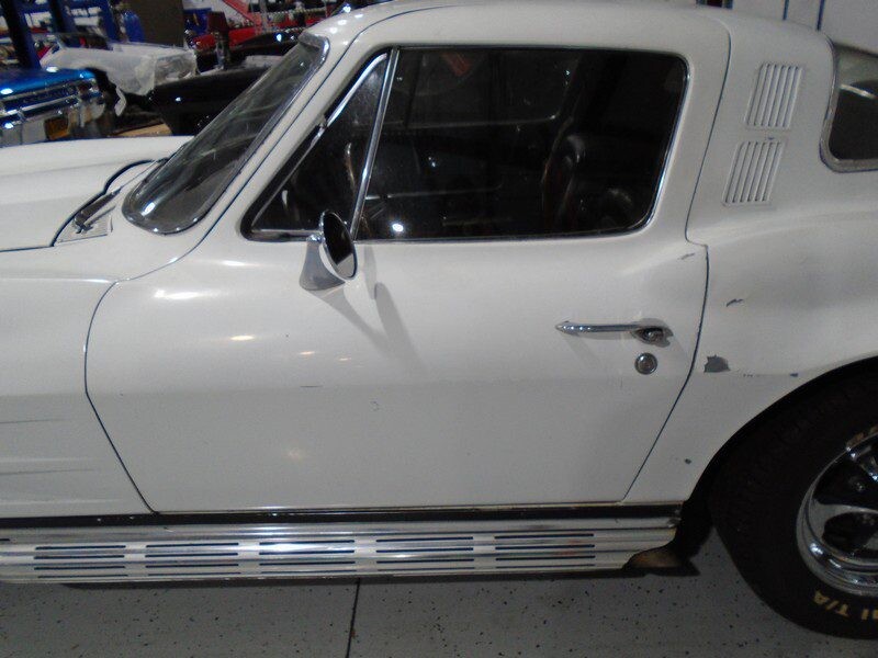 White Corvette's driver side door.