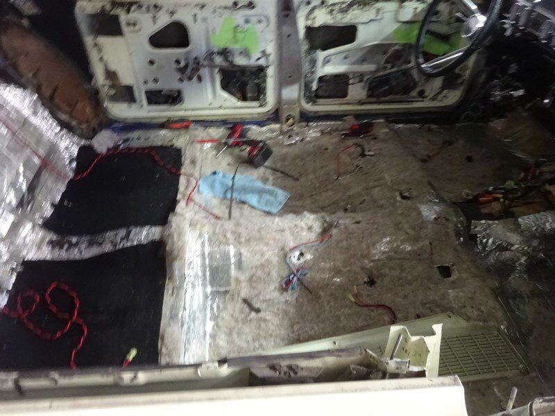 Car interior under repair, messy floor.