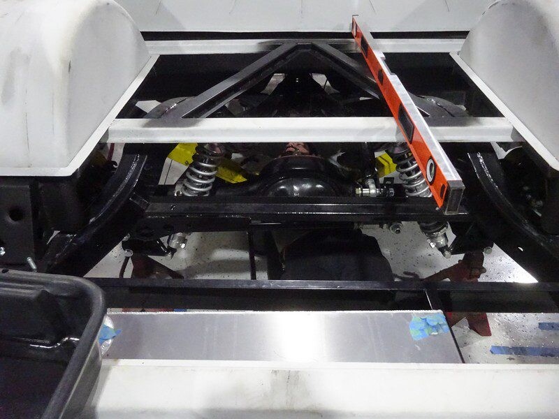 Car chassis under construction, level check.