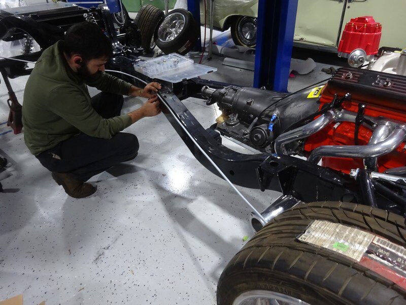 Mechanic installing car frame parts.