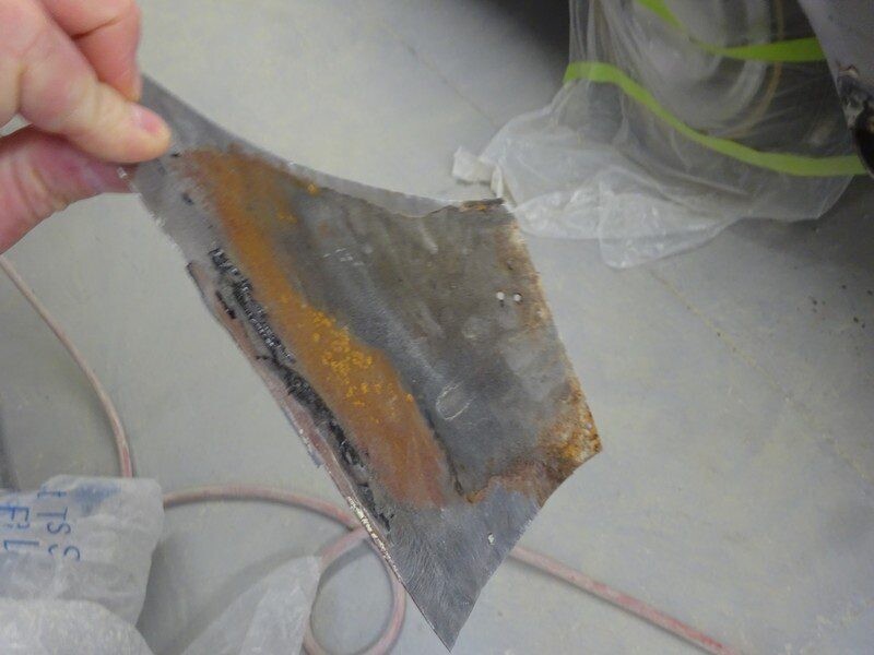 Rusty car part removed for repair.