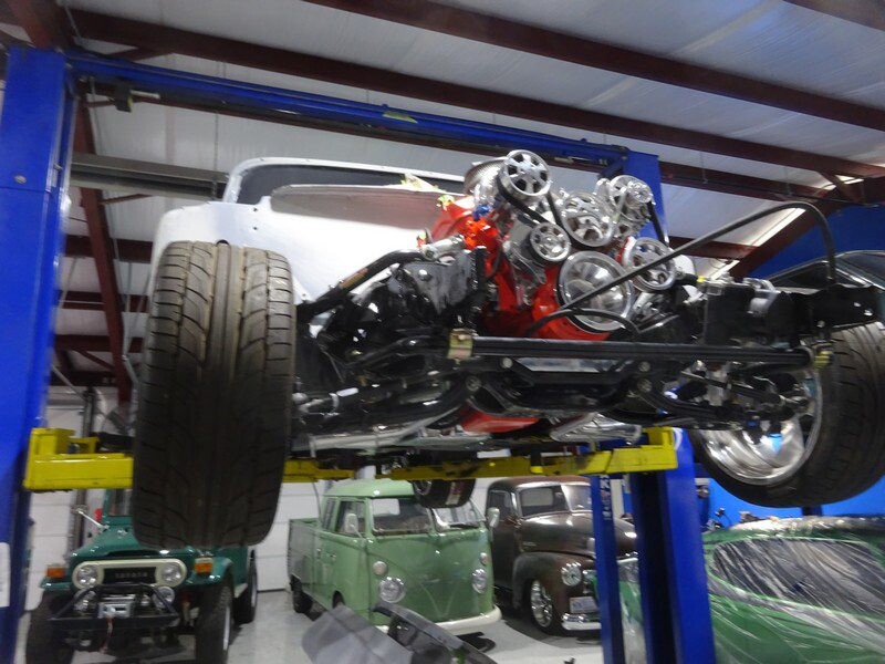 Vintage car chassis and engine on lift