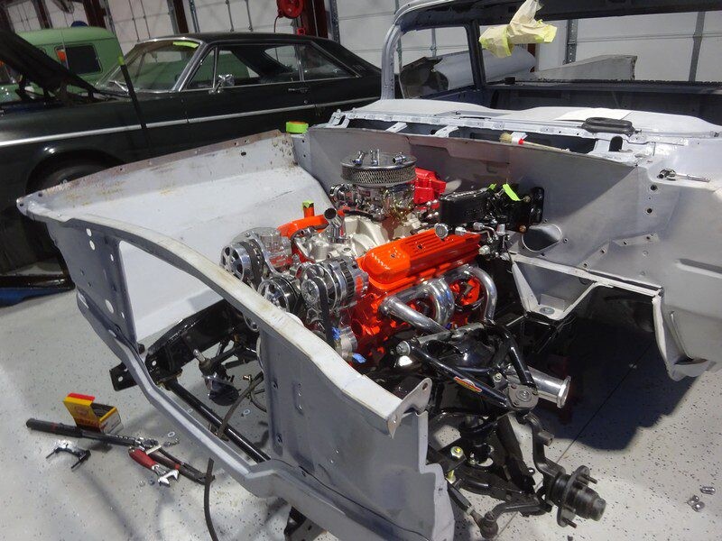 Custom car engine installation in progress.