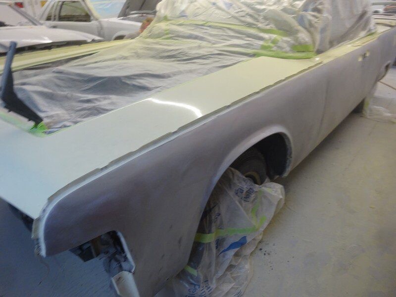 Classic car body undergoing paint restoration.