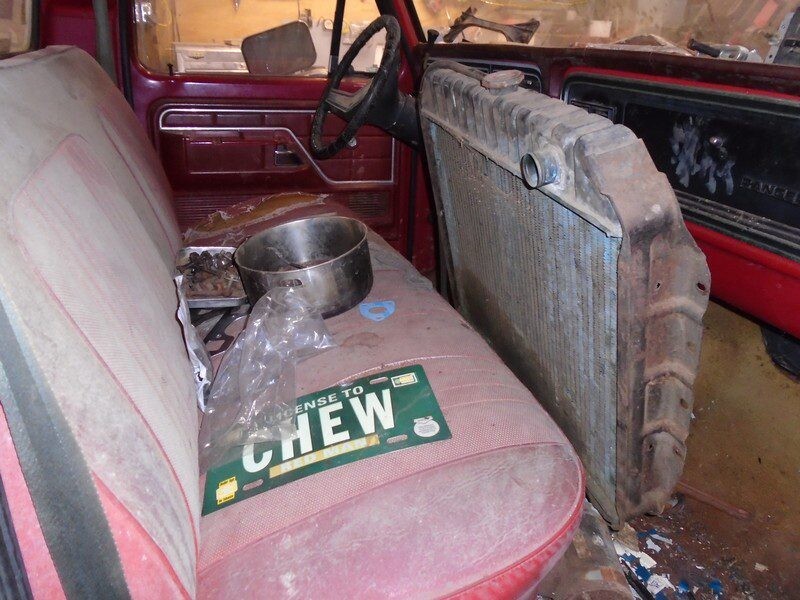 Rusty truck interior with radiator.