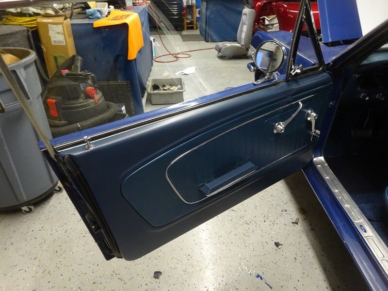 Blue classic car door interior detail.