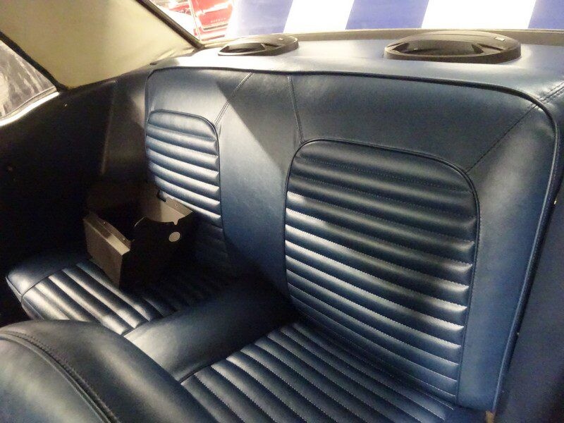 Blue classic car back seat interior.