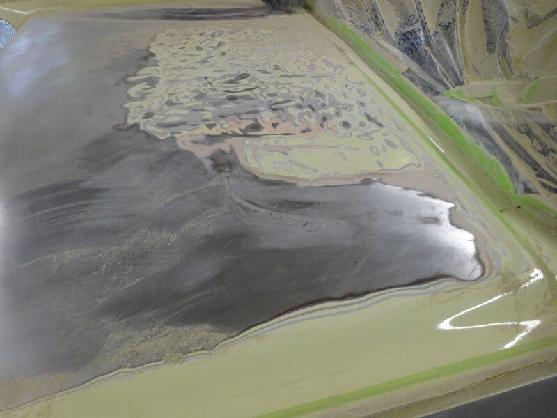 Primed roof section with exposed filler layers