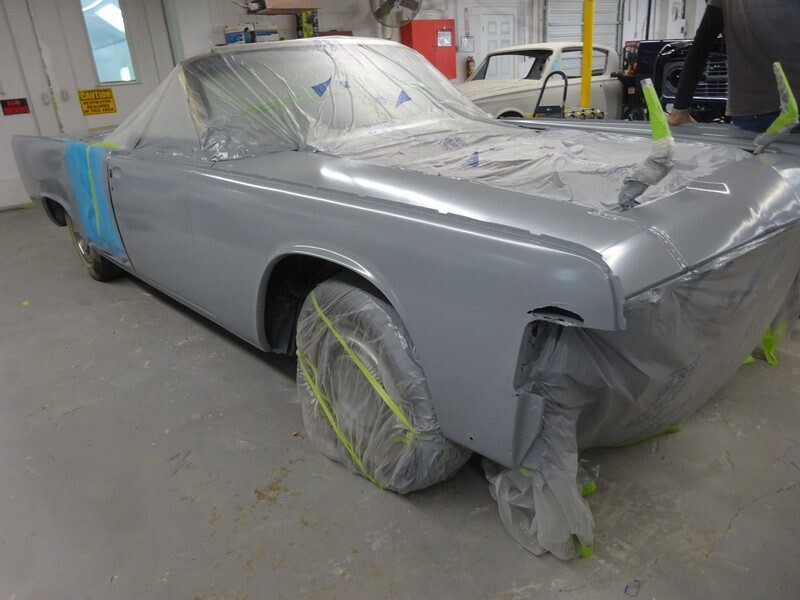 Grey convertible classic car in auto shop.