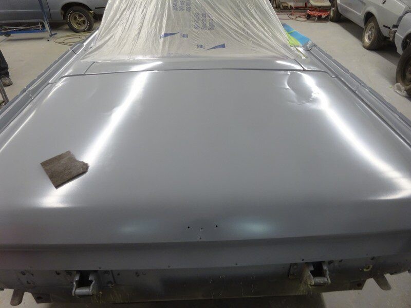 Grey car trunk, primer coat, sanding.