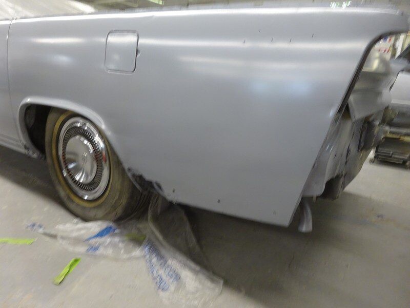 Primered classic car rear quarter panel.