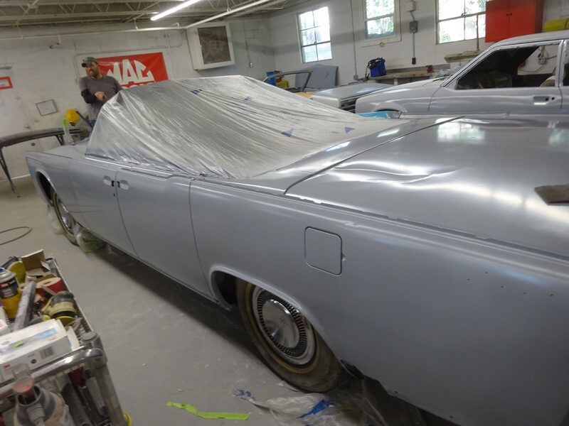 Grey Lincoln Continental in auto body shop.