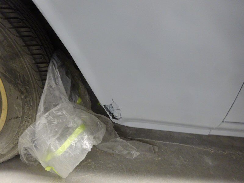 Car fender with paint damage.