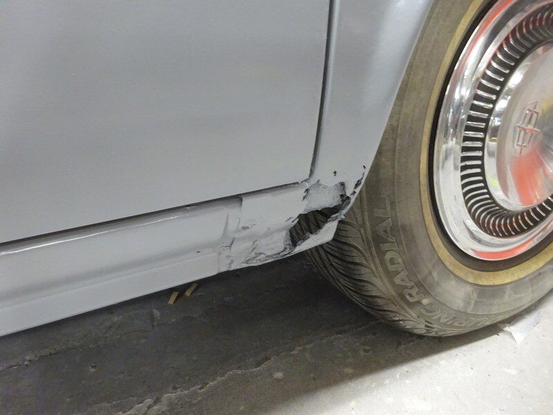 Damaged car fender needing repair.