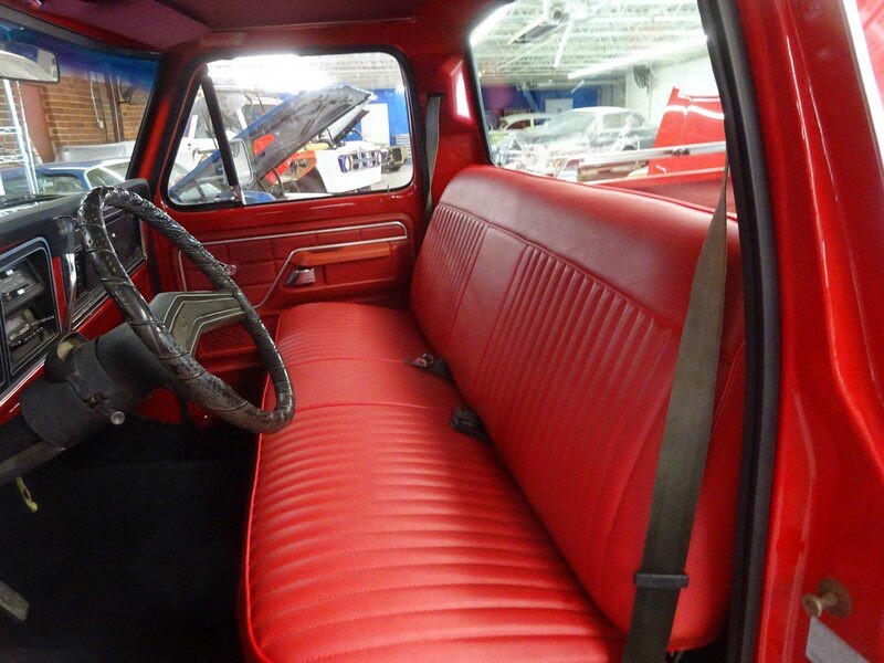 Red interior of classic Ford truck.