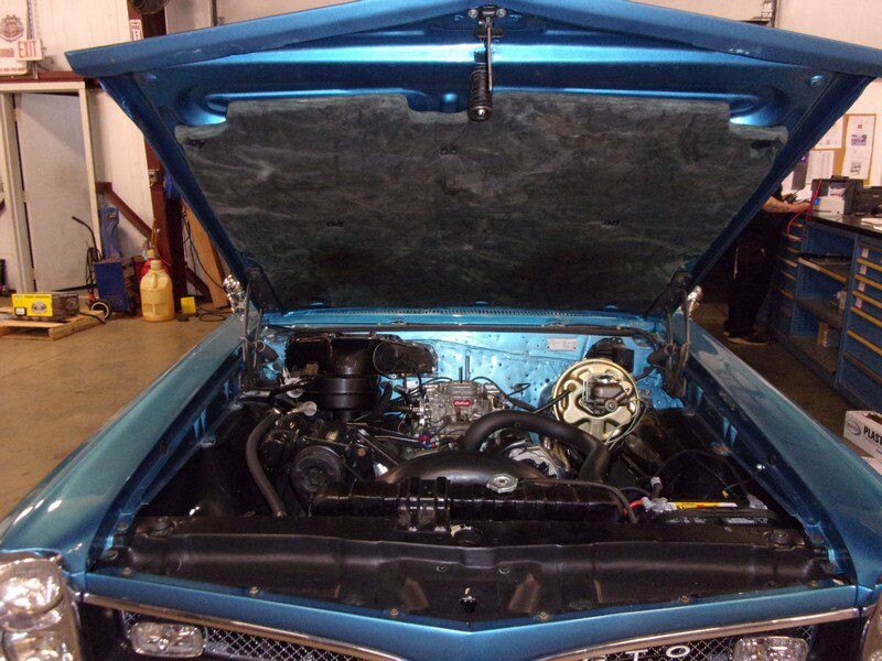 Blue classic car engine bay open.