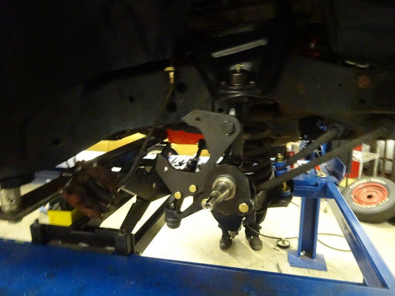 Car rear axle undergoing repair.