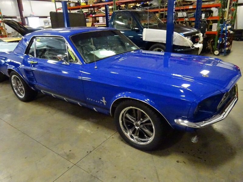 Here's an alt tag for the image: Blue classic Mustang car.