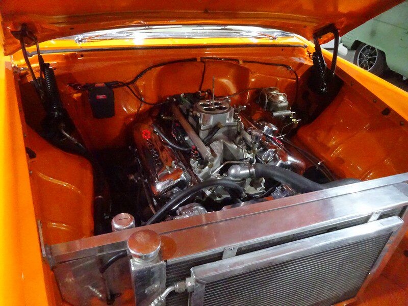 Orange car engine bay detail.