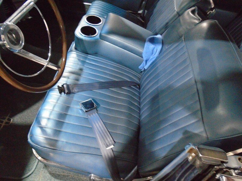 Classic car's blue leather seat and seatbelt.