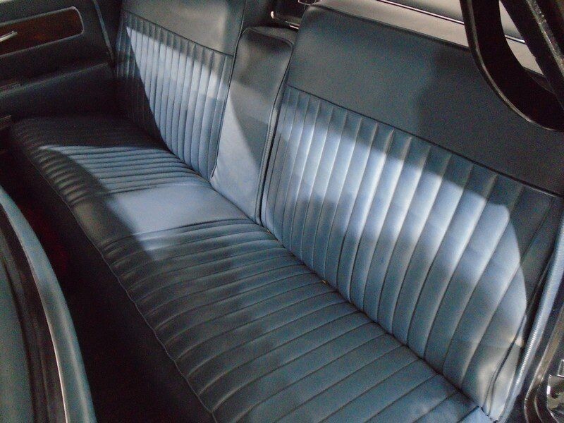 Here's an alt tag for the image: Blue vintage car backseat.