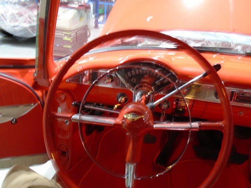 Red classic car interior, steering wheel.