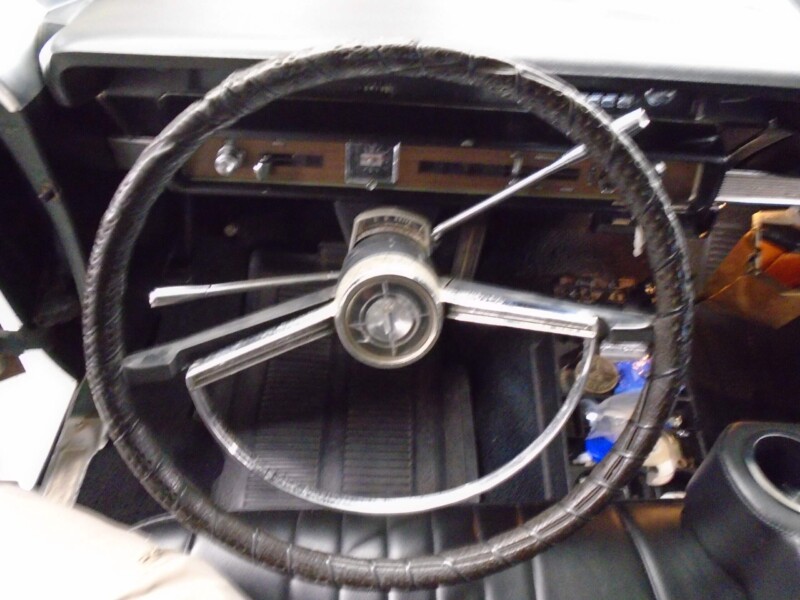 Classic car's steering wheel and dashboard.
