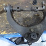 Dirty used car suspension control arm.