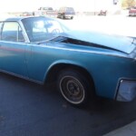 Here's an alt tag for the image: Blue vintage Lincoln Continental restoration project.