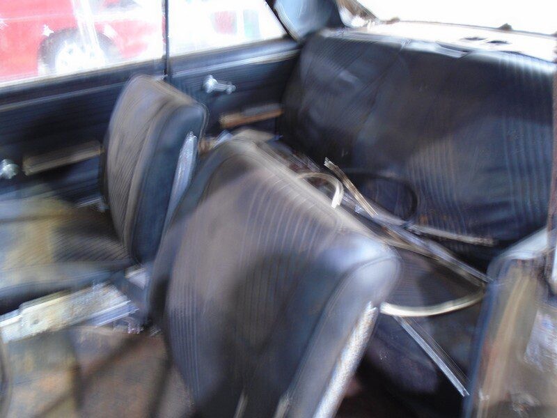 Here's an alt tag for the image: Damaged classic car interior.