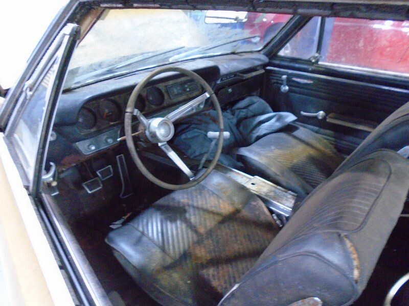 Dirty interior of a classic Pontiac Tempest.