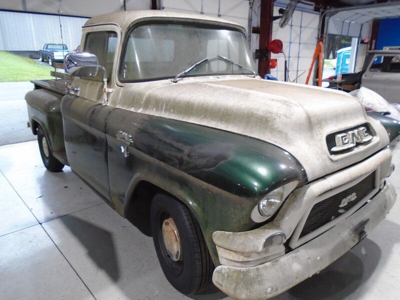 1955 GMC Truck in green and white color kept inside a workshop
