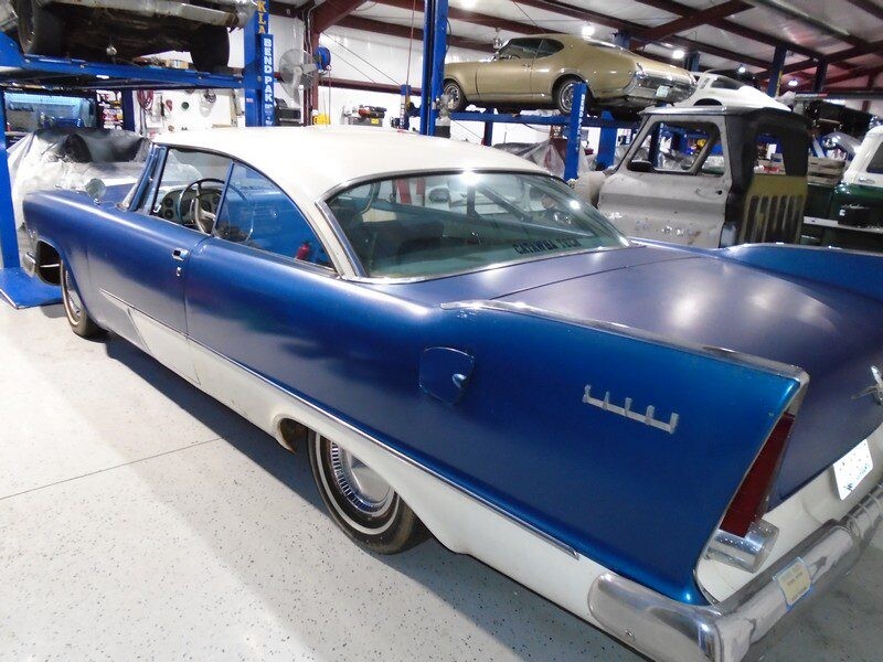 Blue classic car in auto shop.